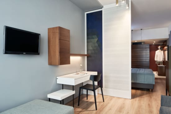 a room with a desk and chairs