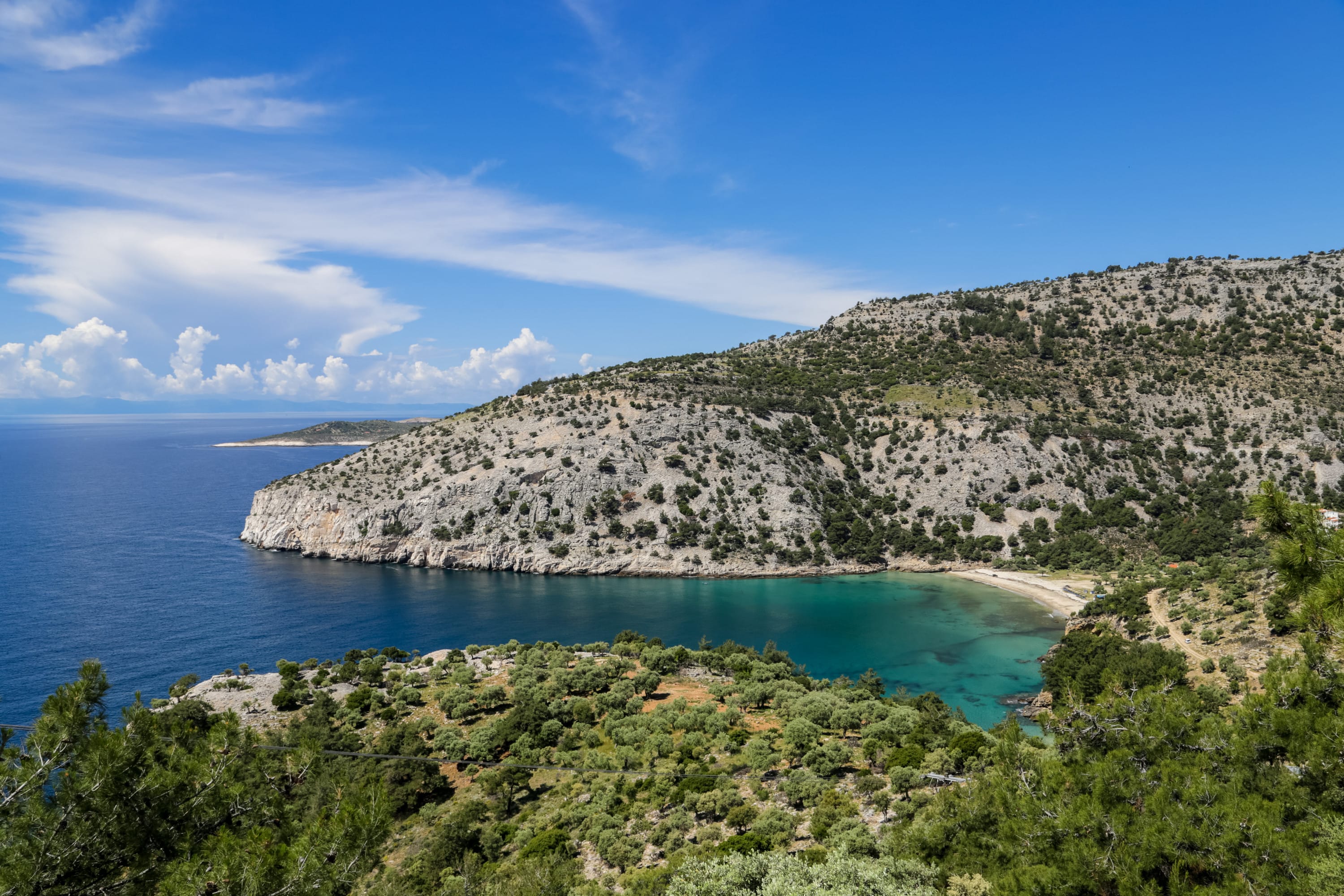 a rocky island with trees and water
