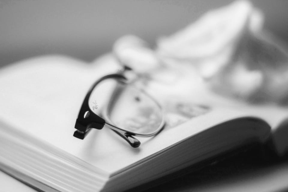 a pair of glasses on top of a book