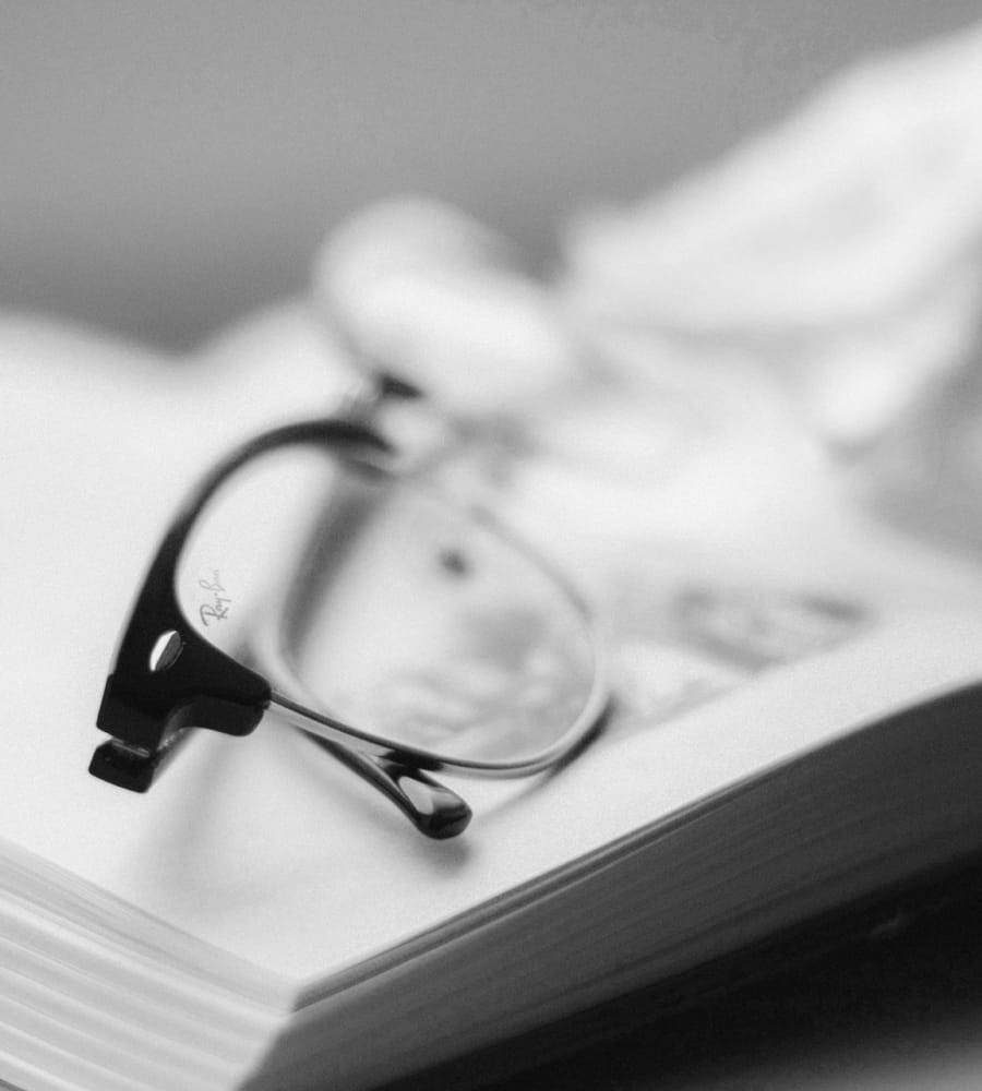 a pair of glasses on top of a book