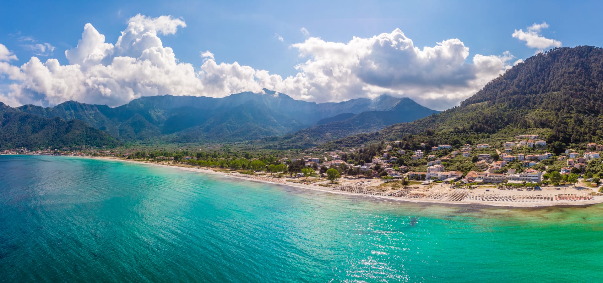 a beach with mountains in the background
