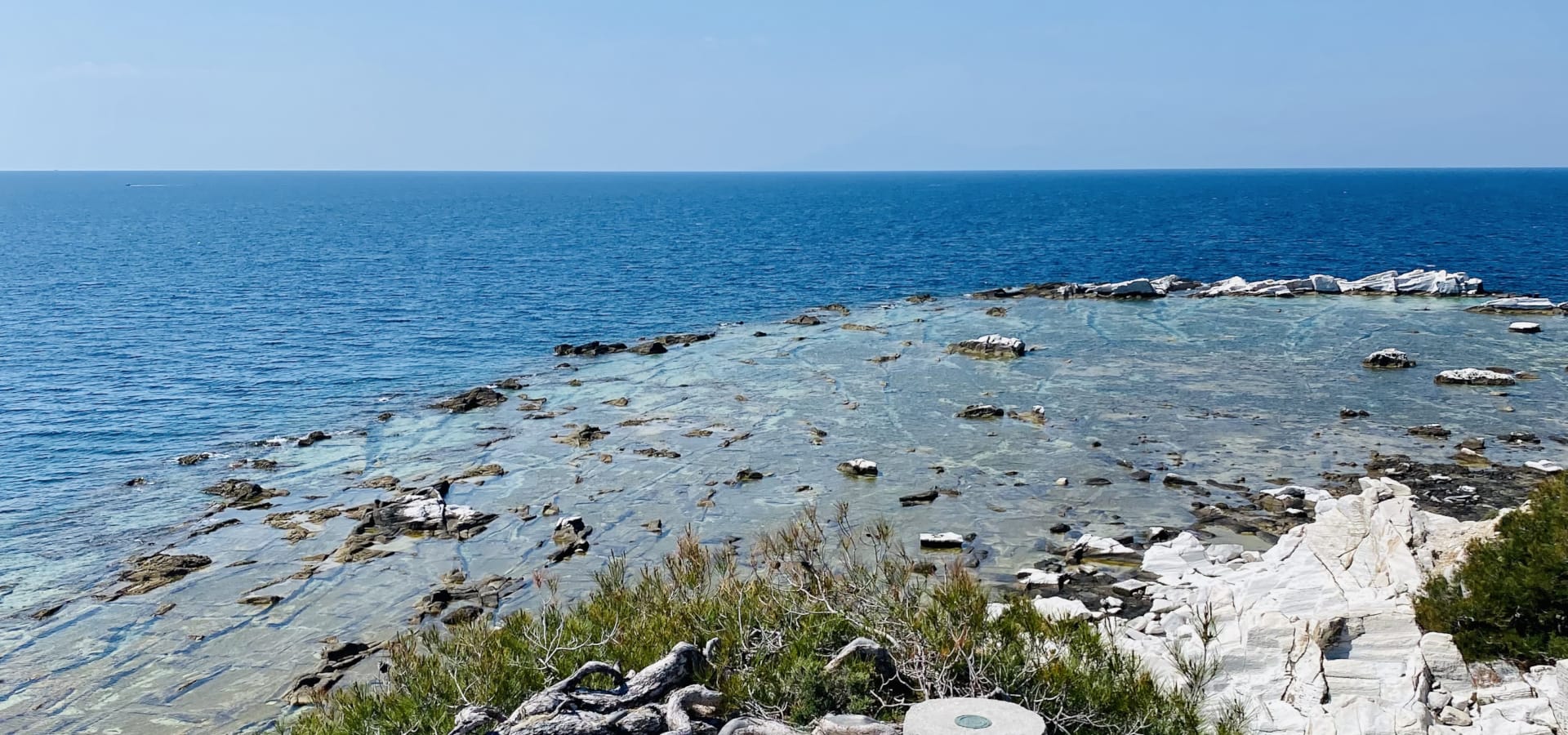 a rocky beach with a stone pillar