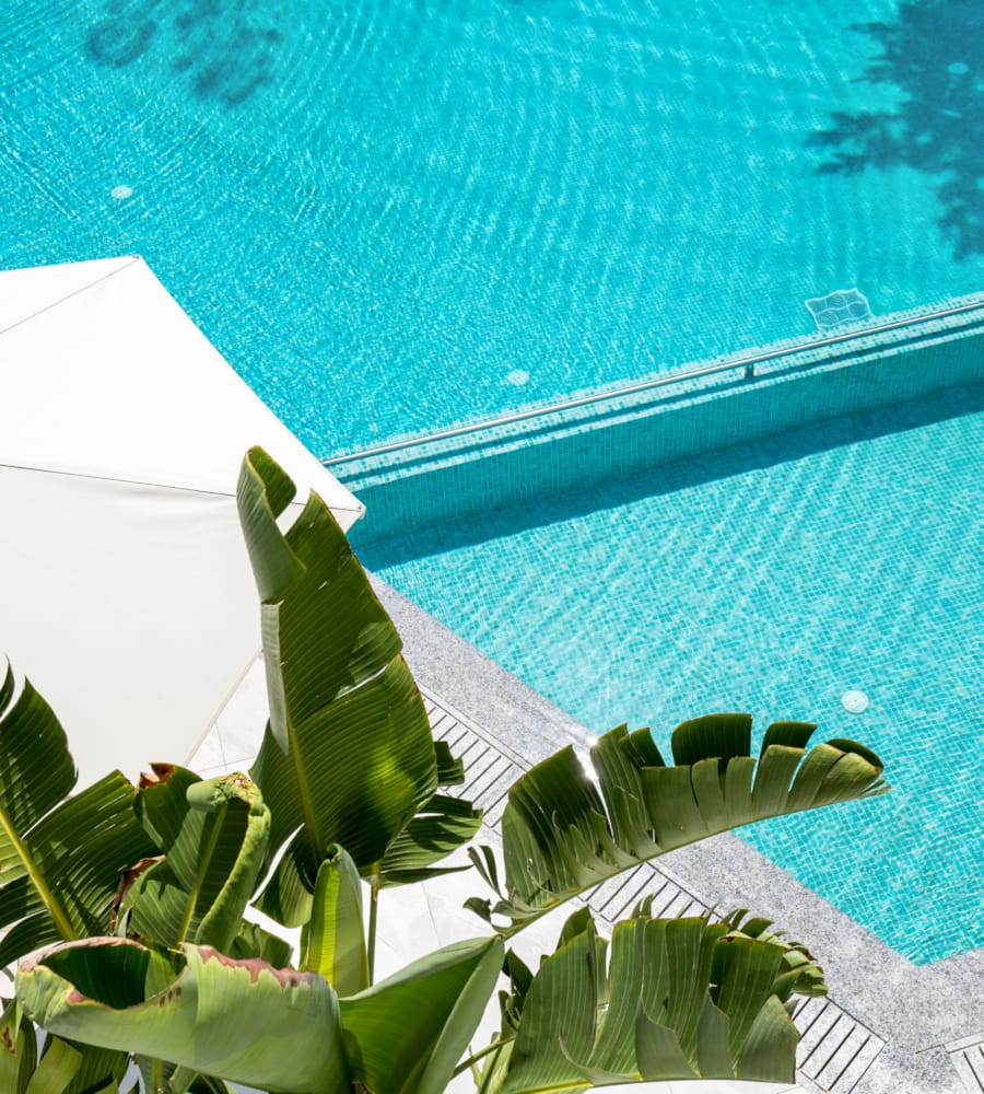 a white umbrella by a pool