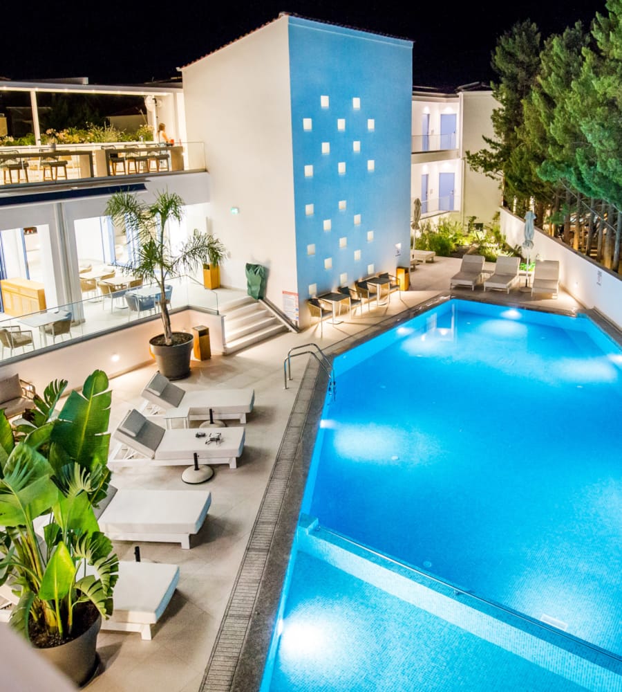 a swimming pool with a building in the background