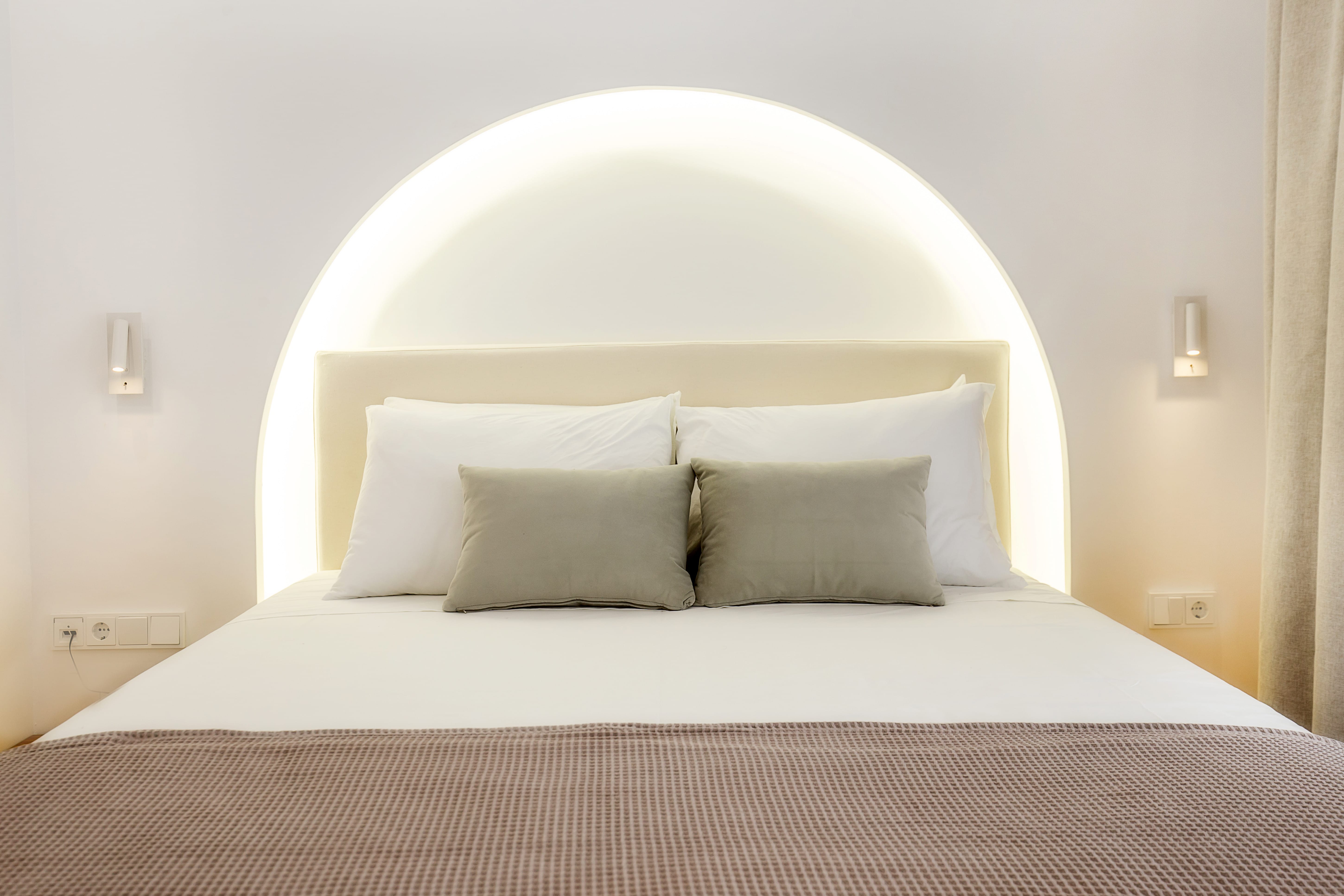 a bed with a white headboard