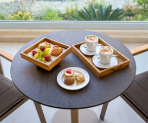 a table with plates of food and cups of coffee on it