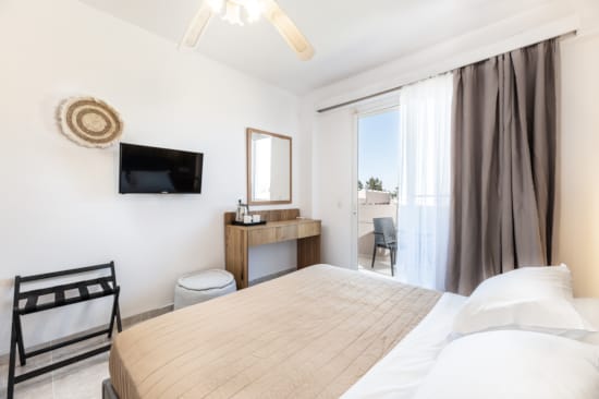 a bedroom with a bed and a chair