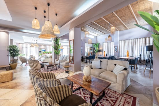 a room with a couch and chairs