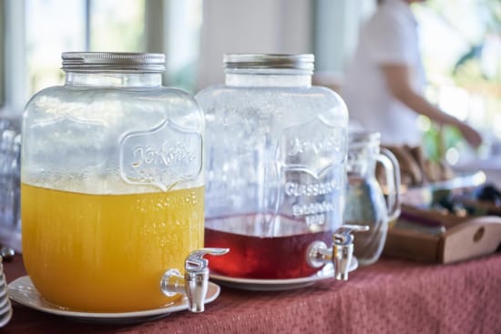 a glass jar with a liquid in it next to a glass jar