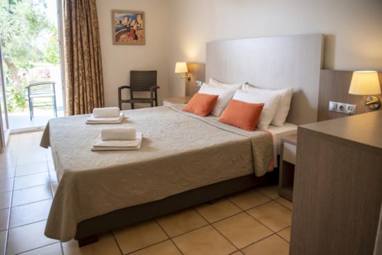 a bed with orange pillows