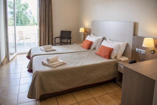 a hotel room with a bed and chairs