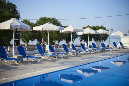 a pool with lounge chairs and umbrellas