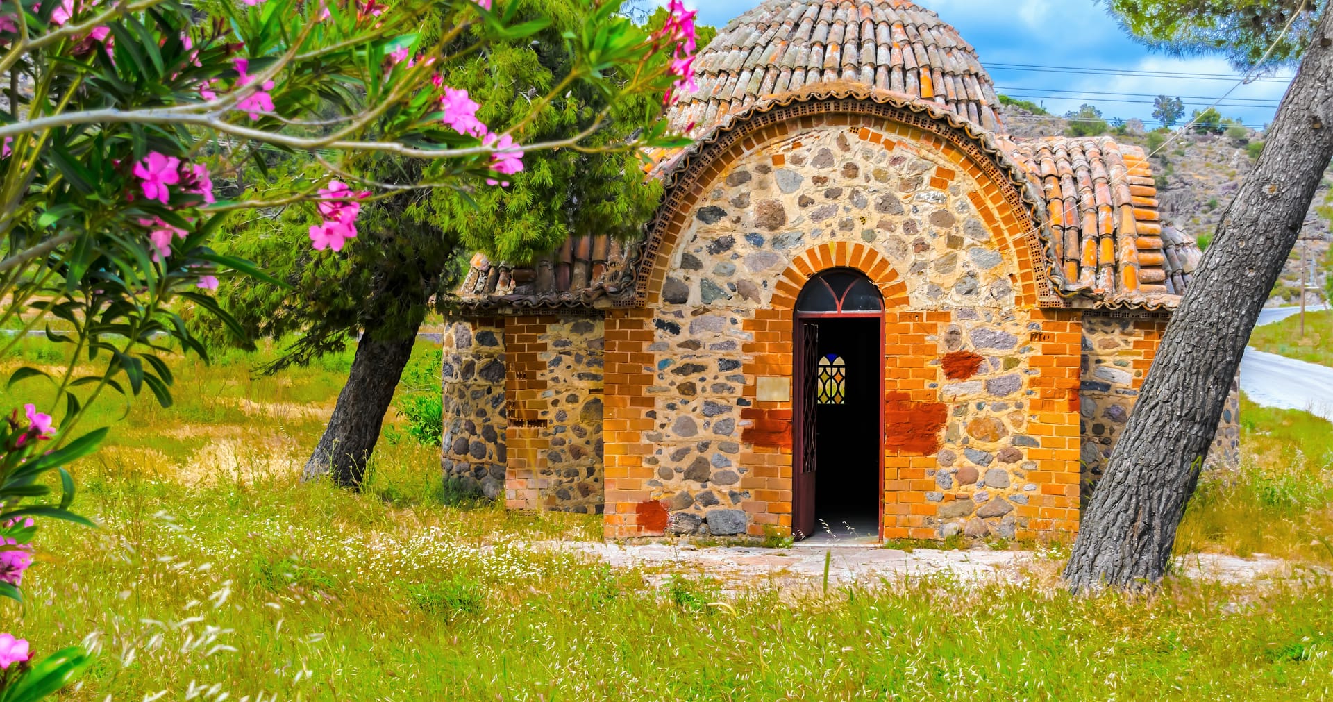a brick building with a door and a tree in front of it