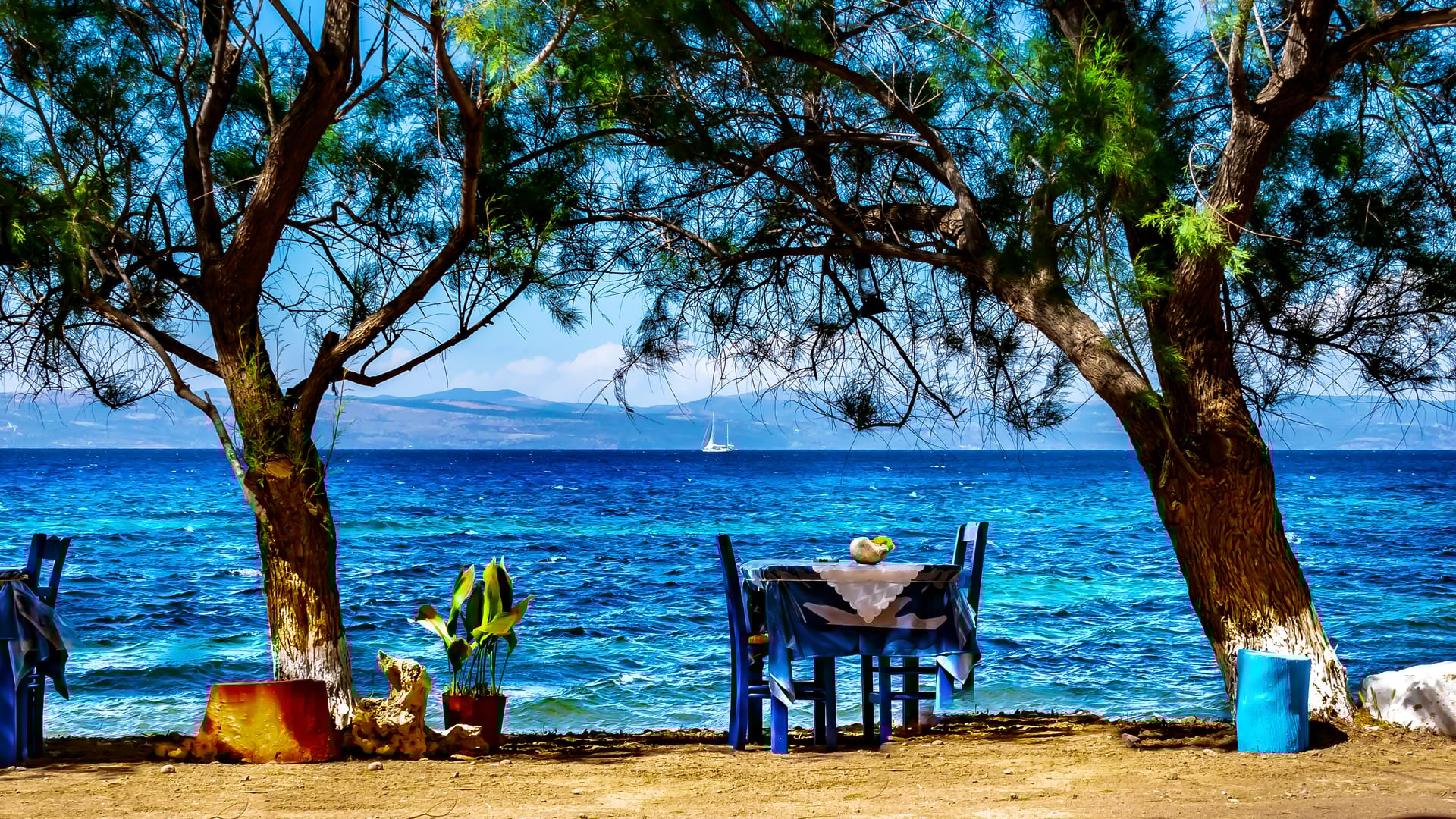 a table and chairs on a beach