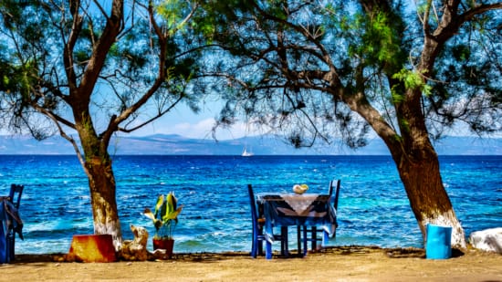 a table and chairs on a beach