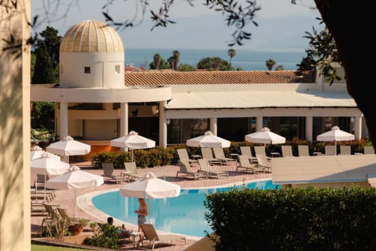 a pool with umbrellas and chairs