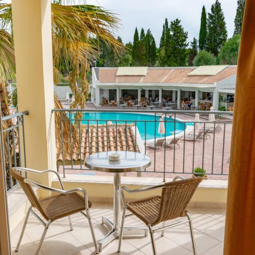 a pool and chairs outside a house