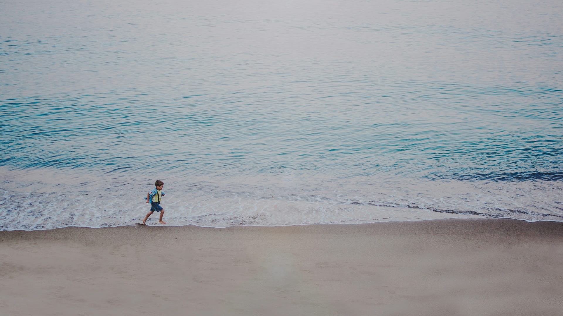 a child walking on a beach