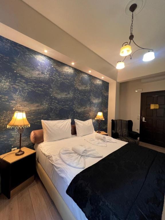 a bed with a painting on the wall