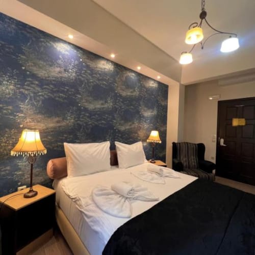 a bed with a painting on the wall