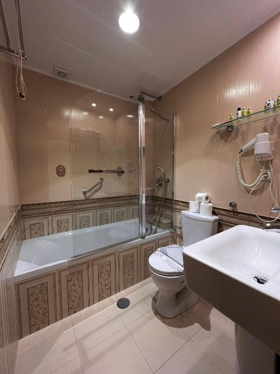 a bathroom with a tub toilet and sink