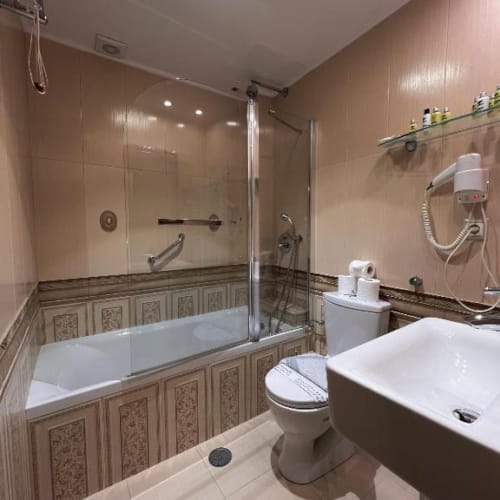 a bathroom with a tub toilet and sink