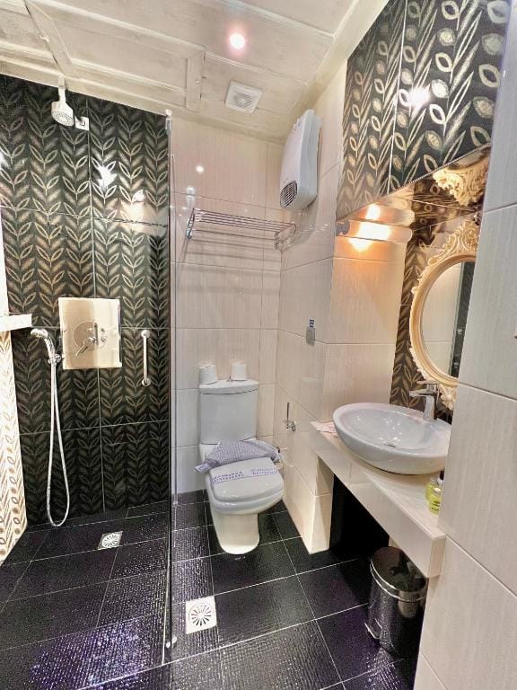 a bathroom with a sink toilet and mirror