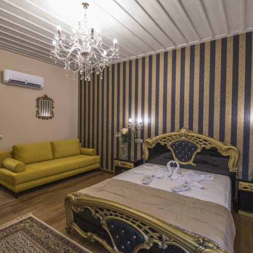 a bedroom with a bed and a couch