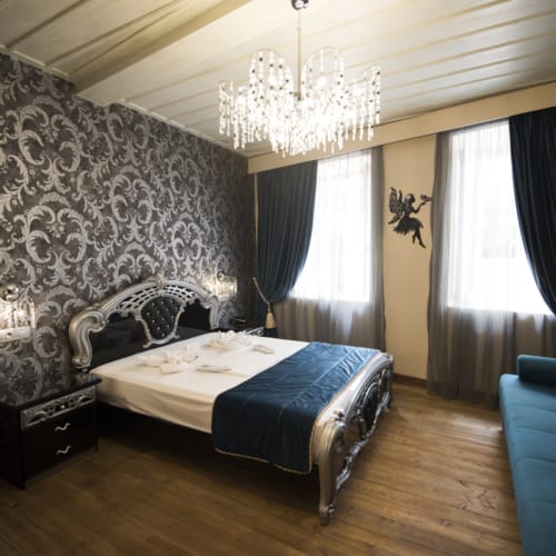 a bedroom with a bed and a couch