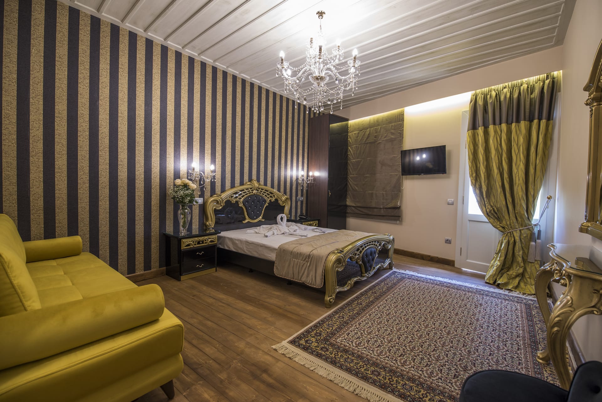 a bedroom with a bed and couches