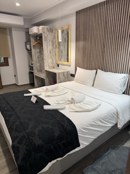 a bed with white sheets and white pillows