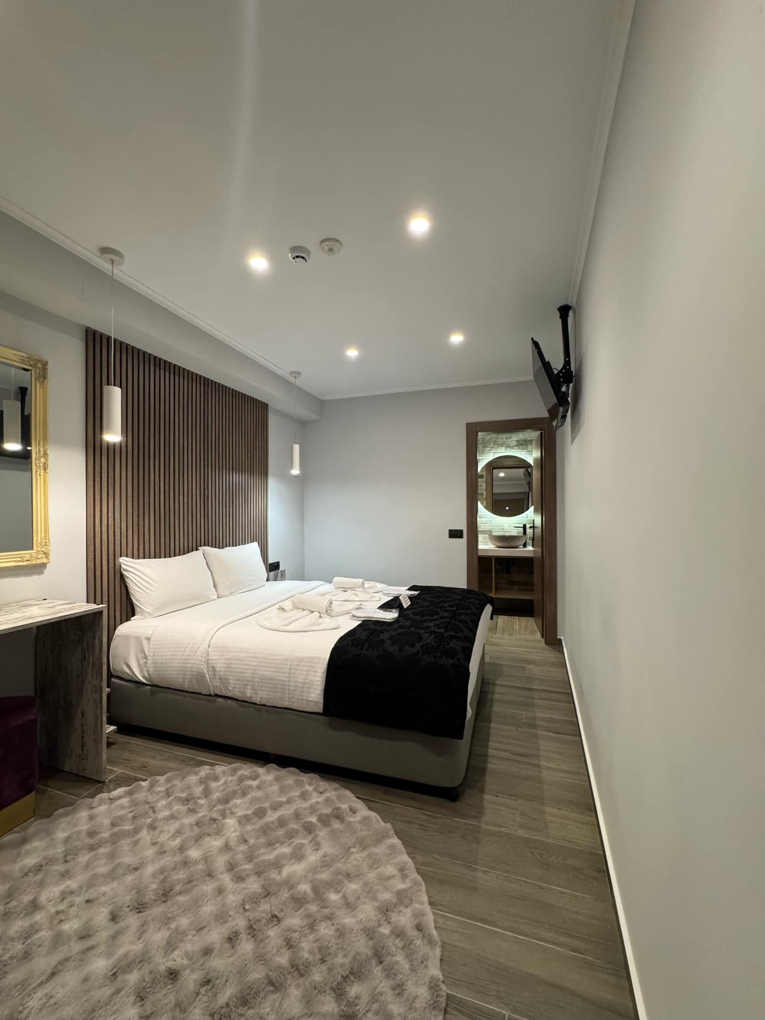 a bedroom with a bed and a rug