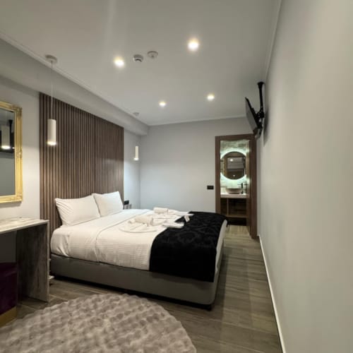 a bedroom with a bed and a rug