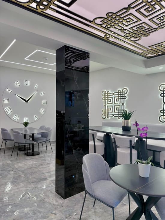 a room with a clock and chairs