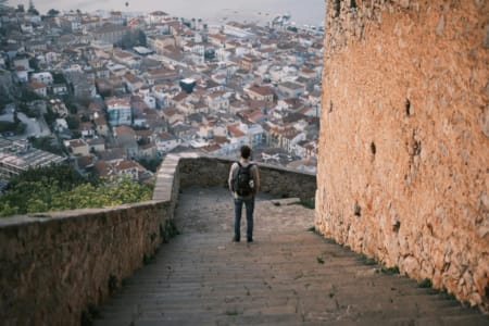 a person standing on a stone bridge