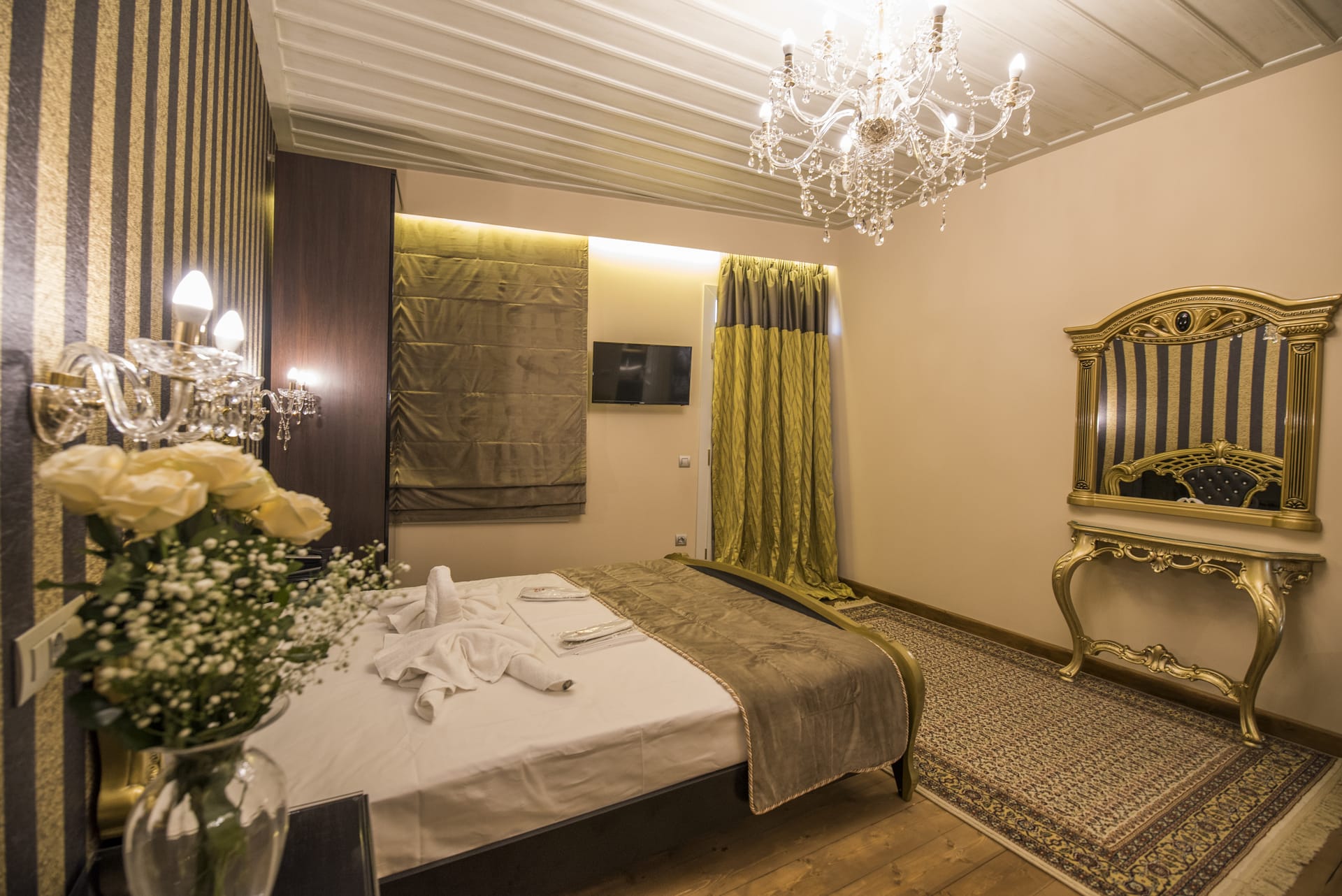 a hotel room with a bed and a chandelier