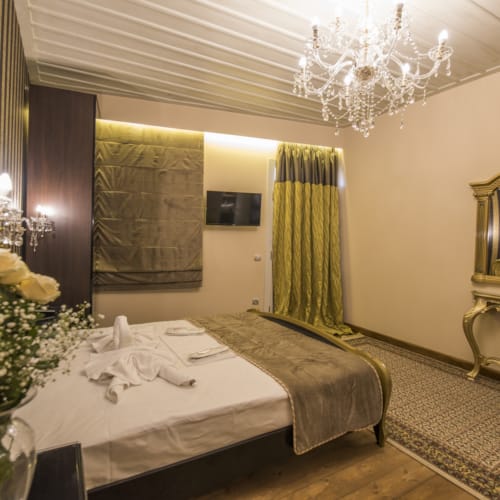 a hotel room with a bed and a chandelier