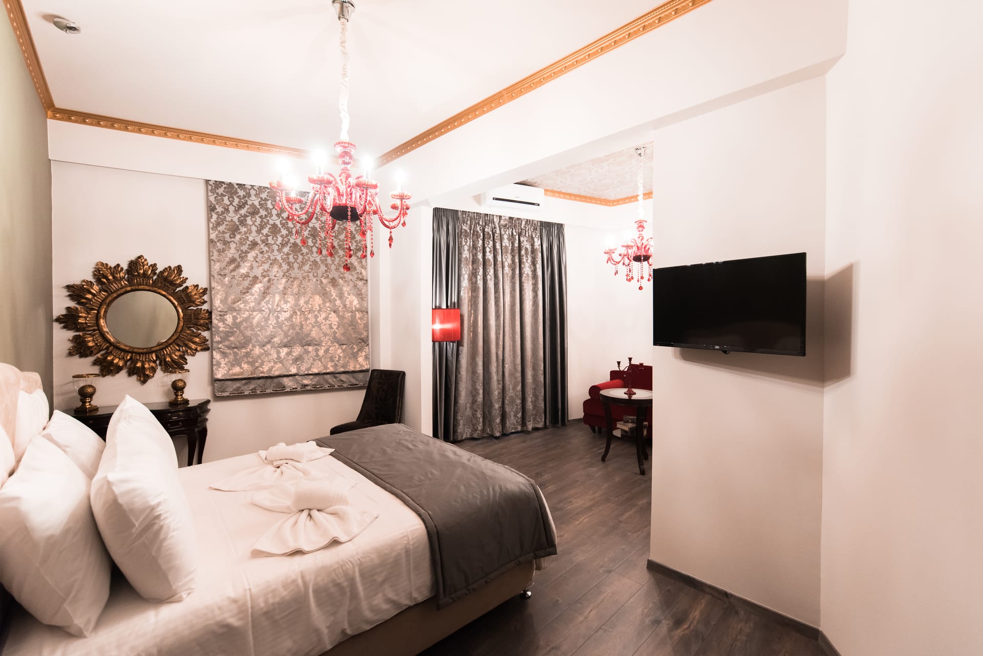 a bedroom with a bed and a television