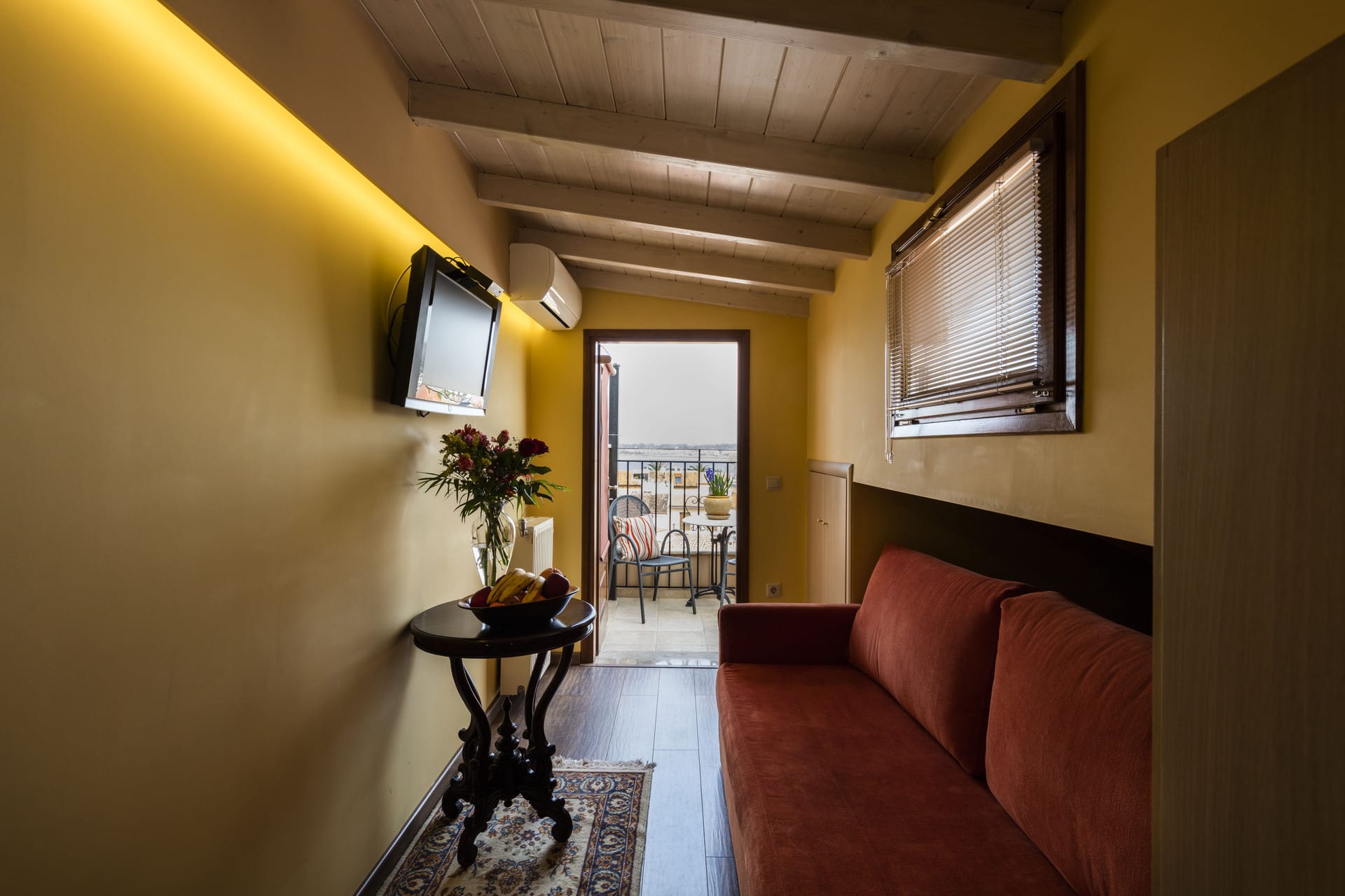 a living room with a tv and couches