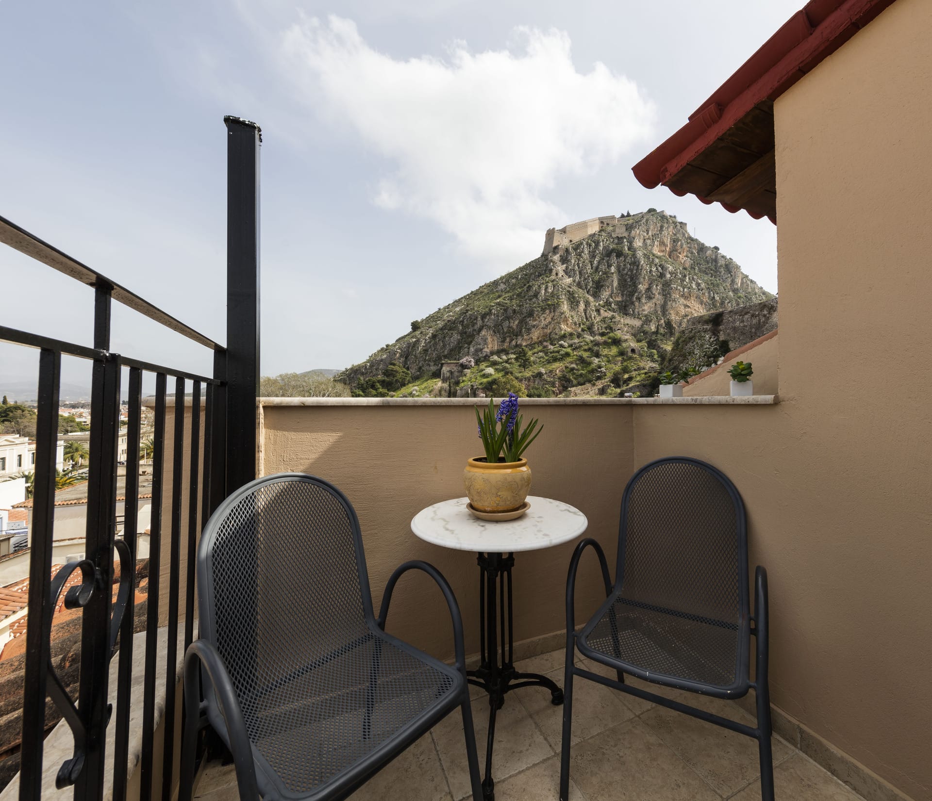 a table and chairs on a balcony