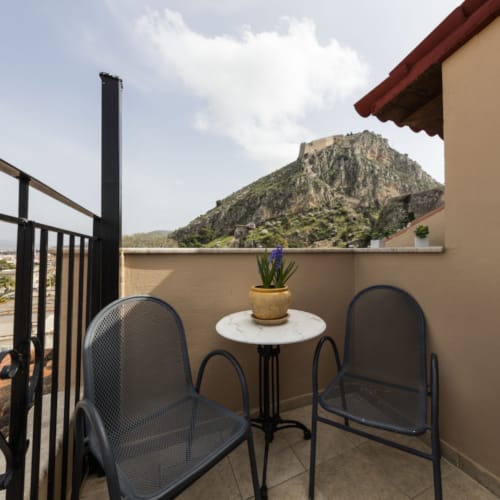 a table and chairs on a balcony