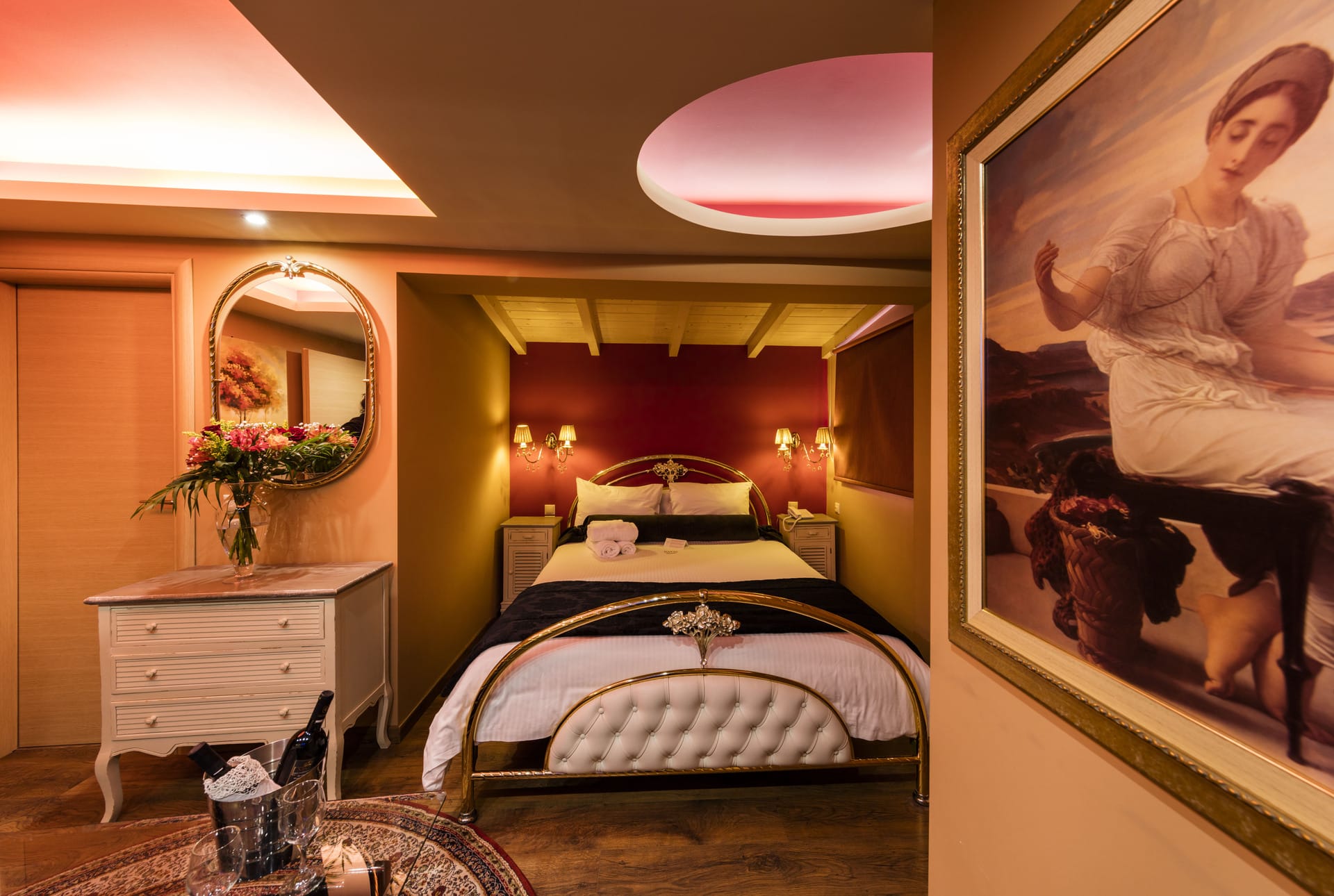 a bedroom with a large painting