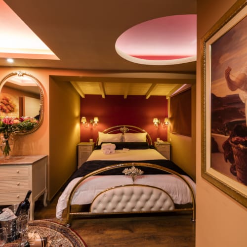 a bedroom with a large painting