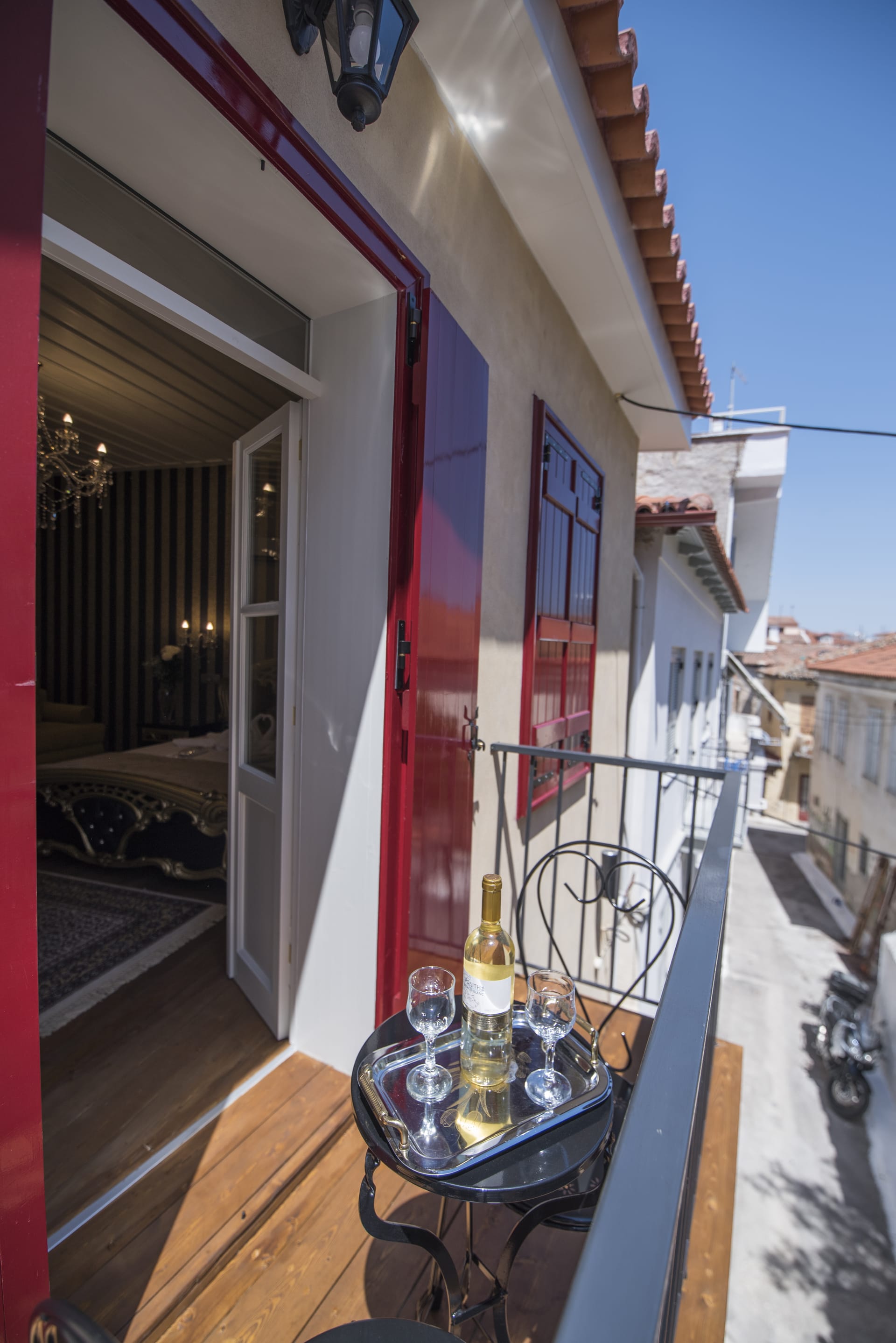 a table with a bottle of alcohol on it outside a building