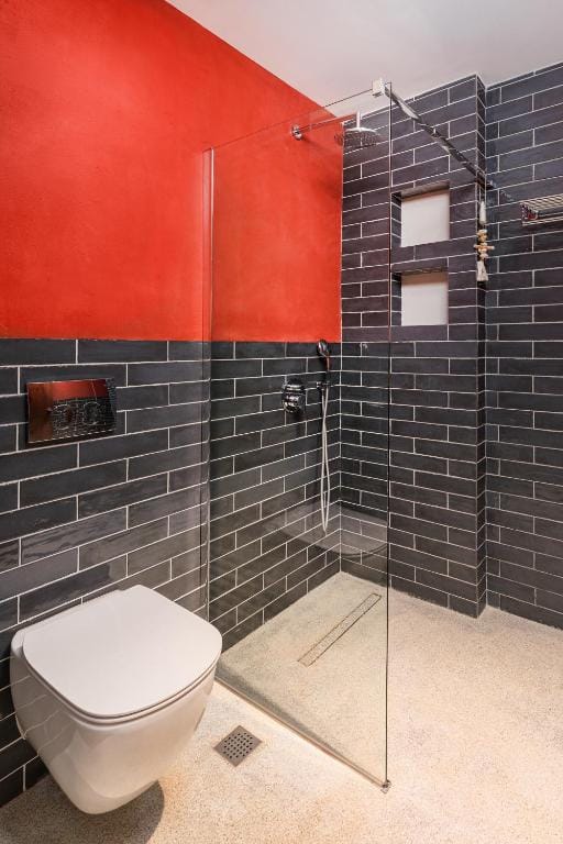 a bathroom with a toilet and a shower unit
