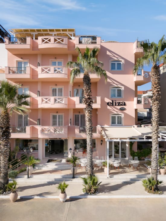 a building with palm trees in front