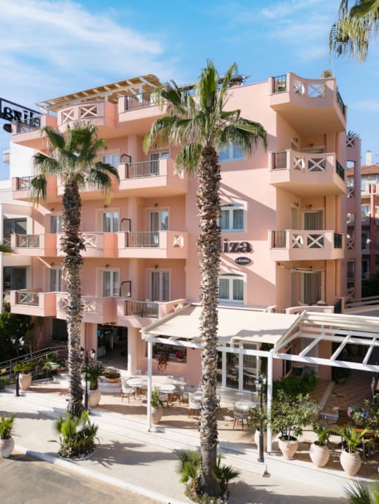 a building with palm trees in front