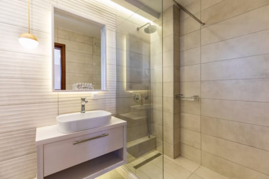 a bathroom with a sink and a shower unit