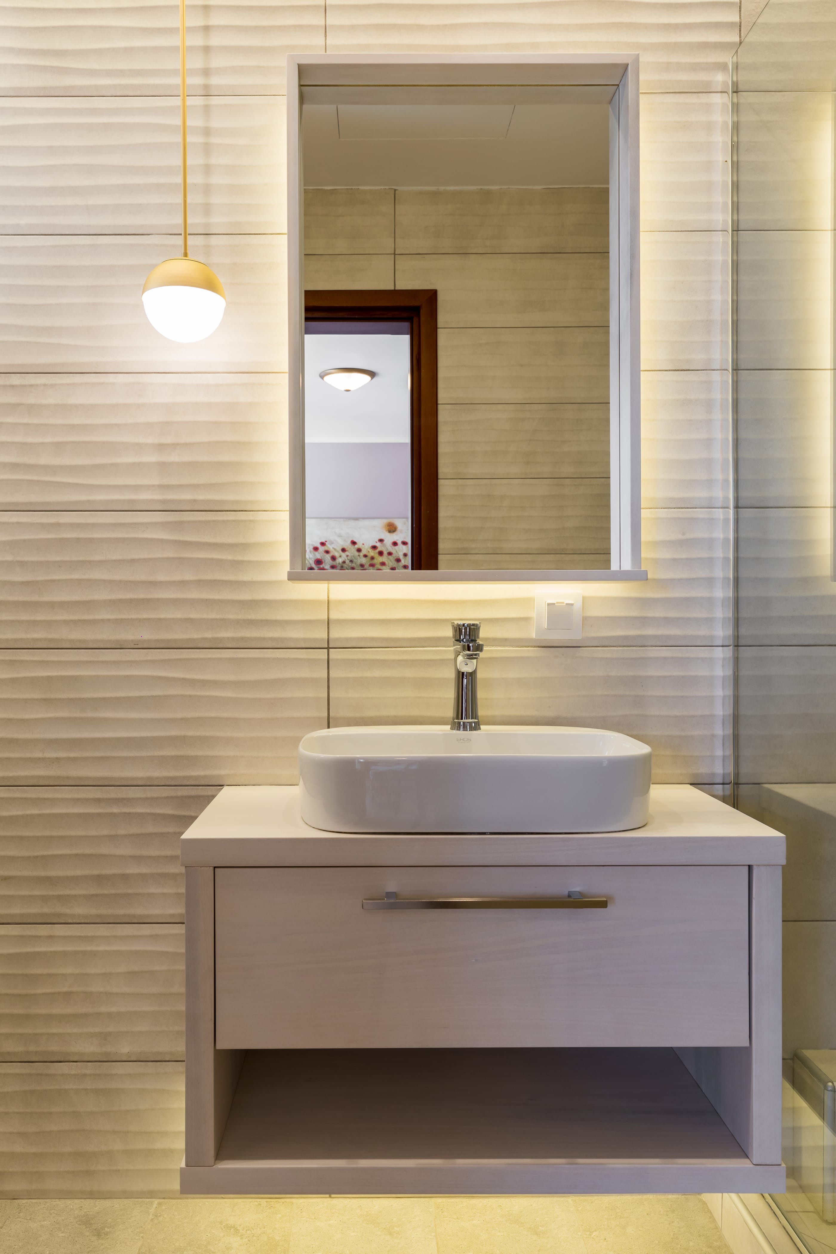 a bathroom with a mirror and sink