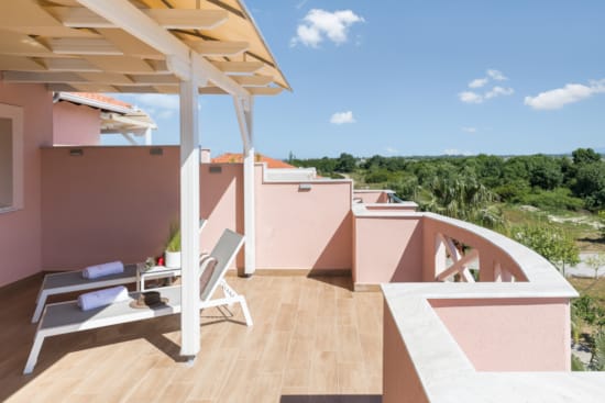 a deck with a deck and a house with trees in the background